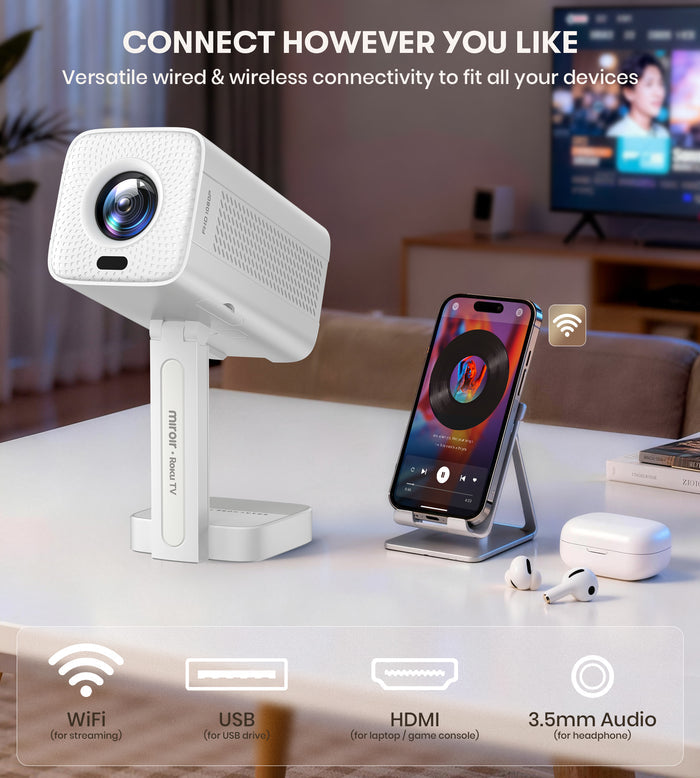 White camera device on a table with smartphone, earbuds, and TV in the background.