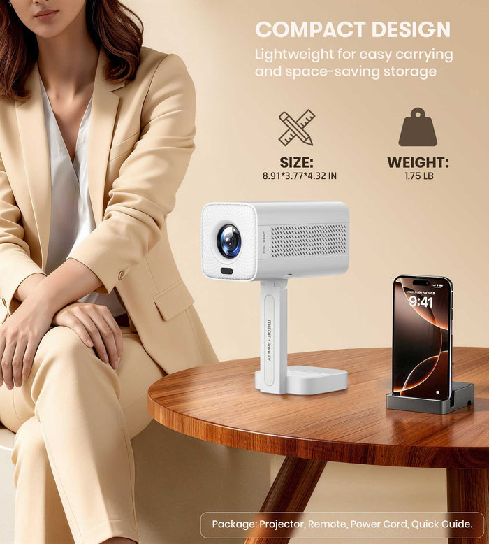 Woman in a beige suit sitting next to a compact projector and smartphone on a table.
