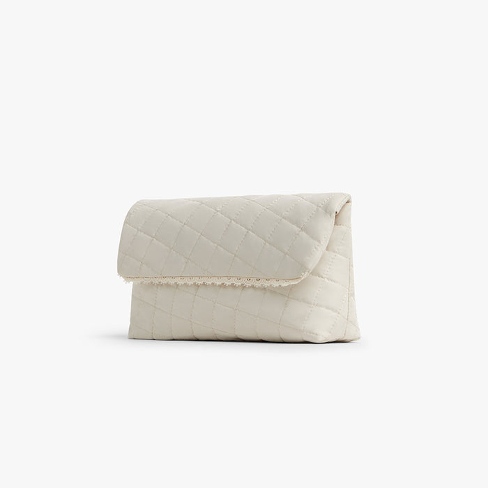 Cream | Side view of Monos x Reformation cosmetic pouch in cream