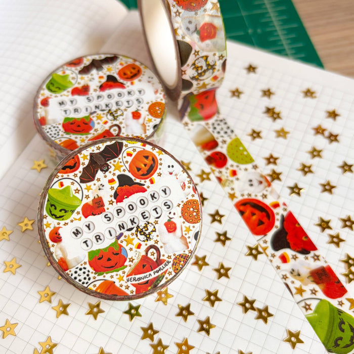 Decorative washi tape featuring spooky illustrations from Veronica Porlier, shown rolled out with Halloween-themed designs.