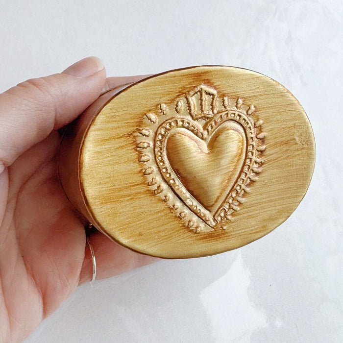 Oval brass heart-shaped trinket box by Saint Austin Company, decorative jewelry or keepsake storage.