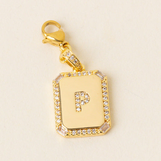 The P Jewelry Charm Initial Letter Gold by the-darling-effect is a personalized gold pendant with a diamond-encrusted border and a diamond-studded letter P on a white background—perfect for initial jewelry lovers.
