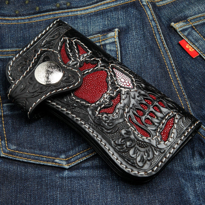 A close-up angle of the red stingray skull wallet, showing the silver snap closure and contrast stitching.