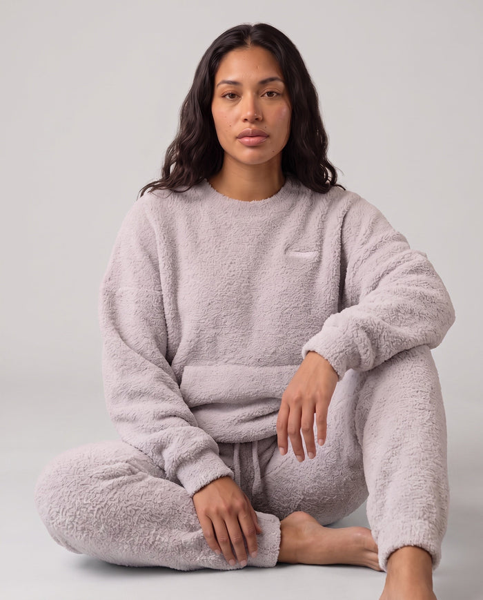 Model wearing the Plush Mode set, seated