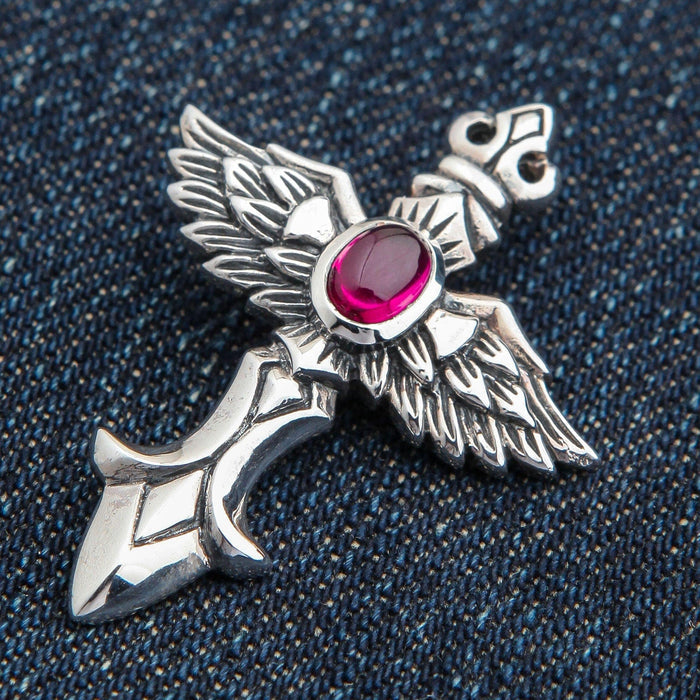 An alternative angle of the biker angel wing jewelry, focusing on the ornate, fleur-de-lis style top.