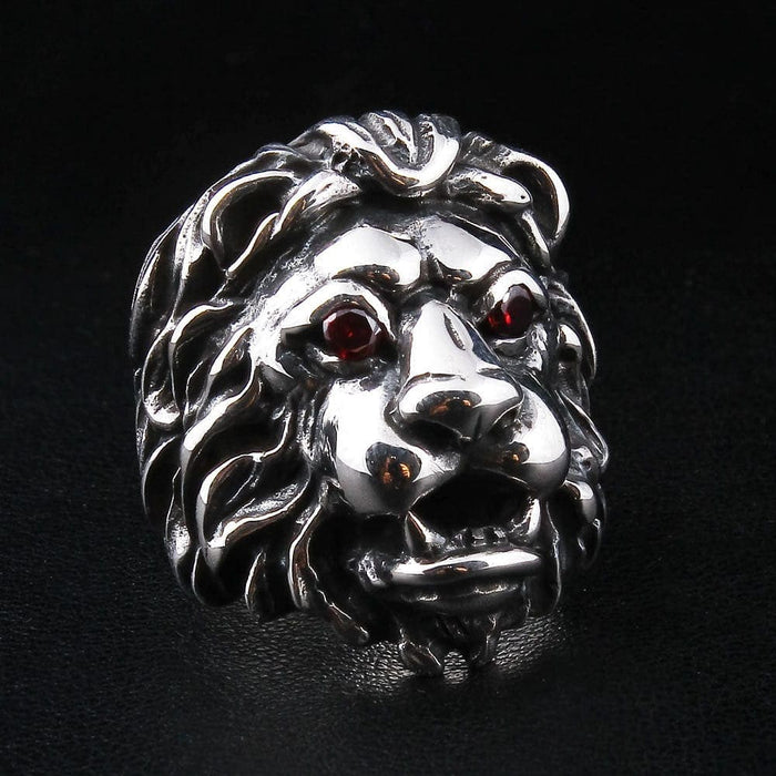 Close-up detail of the red eyes and snarling teeth on the biker lion ring.
