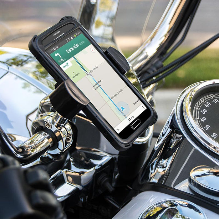 The RoadVise® XL Motorcycle Midsize Tablet and Phone Mount - Chrome Aluminum securely grips a smartphone showing a navigation map on the handlebars, with chrome bike parts and the speedometer in view.