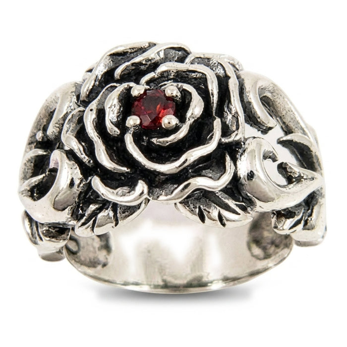 Front view of oxidized .925 silver rose ring showing four prongs holding a red garnet stone in the rose center