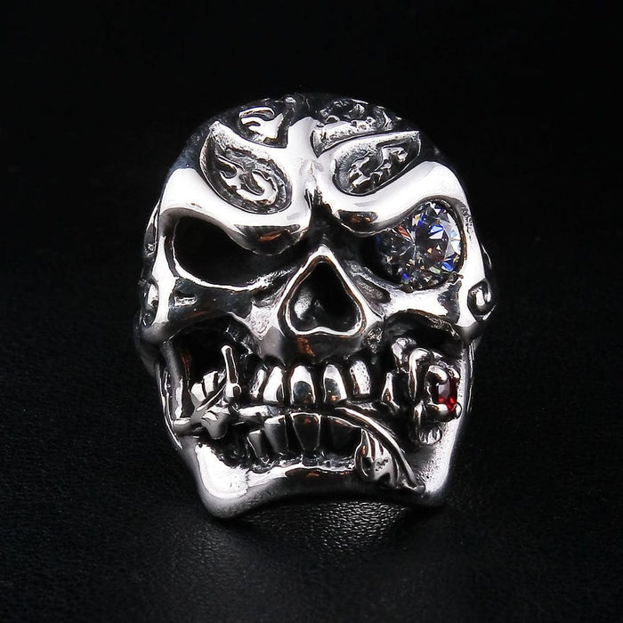 Front view of the sterling silver rose skull ring, showing the detailed carving and the red garnet in the rose.