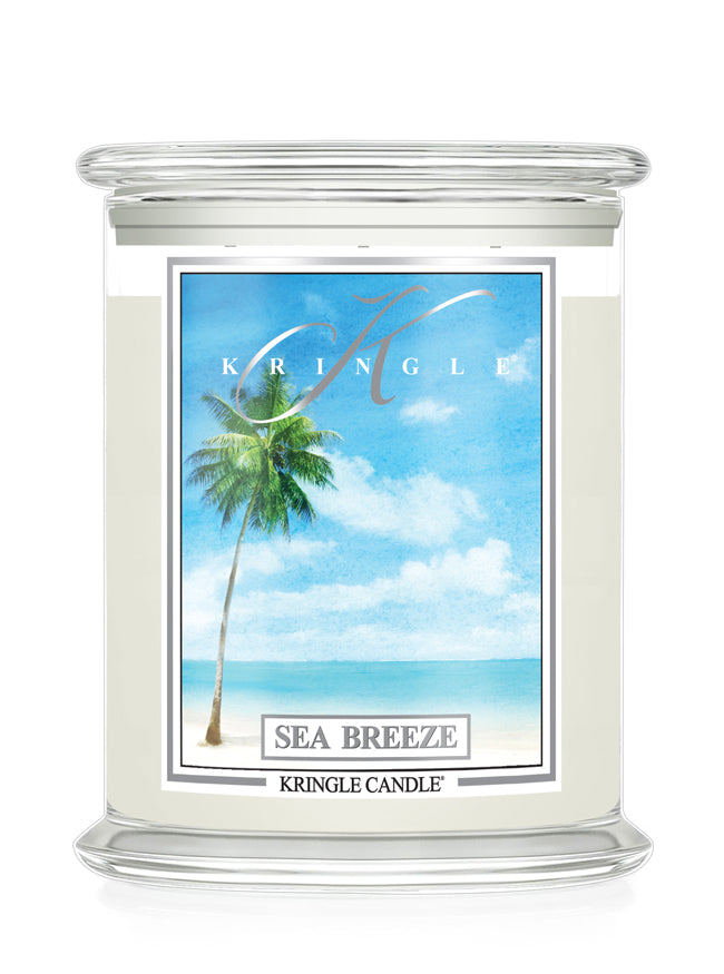 Kringle Candle with 'Sea Breeze' label featuring a palm tree and beach scene on a white background