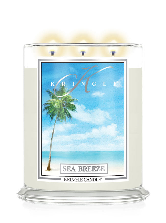 Kringle Candle with 'Sea Breeze' label featuring a palm tree and beach scene on a white background
