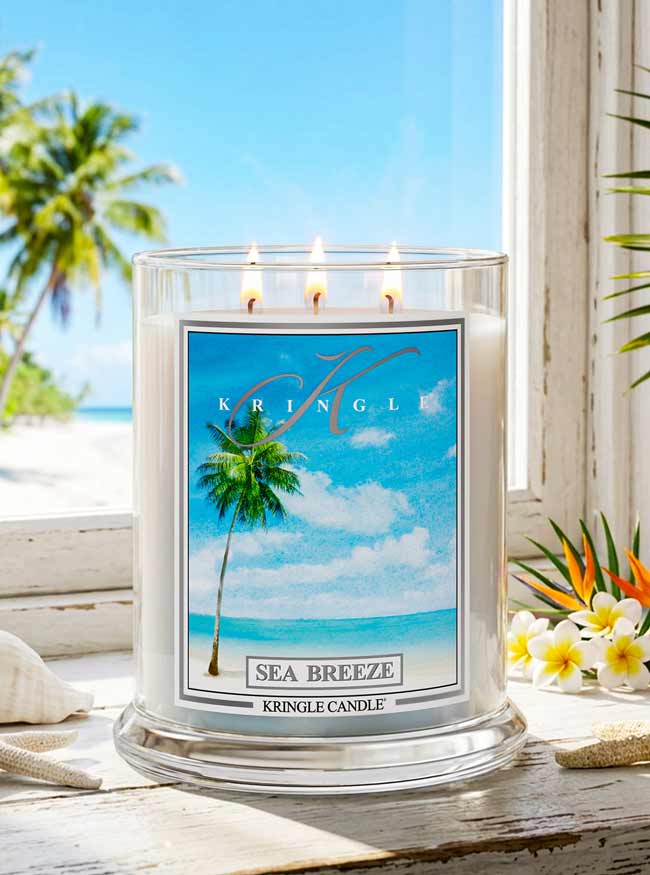 Kringle Candle with 'Sea Breeze' label on a beach-themed background