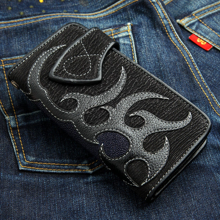 A one-of-a-kind wallet featuring a unique combination of rugged black shark skin and pebbly navy blue stingray.
