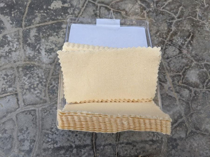 Single SilverBlue soft cotton polishing cloth displayed outside open box showing cream colored pre-infused fabric texture
