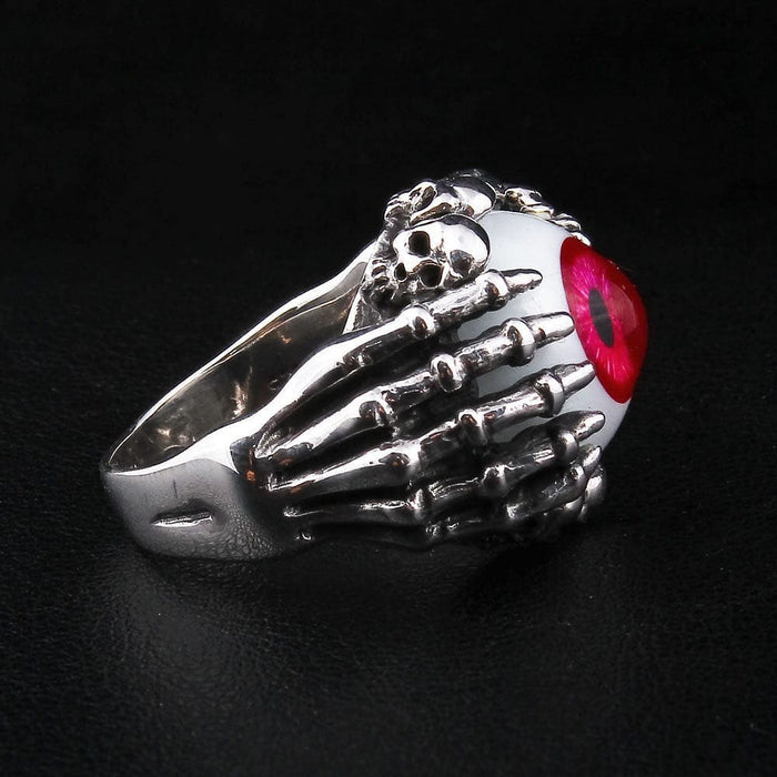Angled view of 925 sterling silver skeleton ring displaying small skull accents and craftsmanship