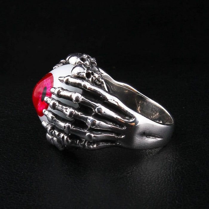 Opposite side view of sterling silver gothic claw ring with red eyeball and bone texture details