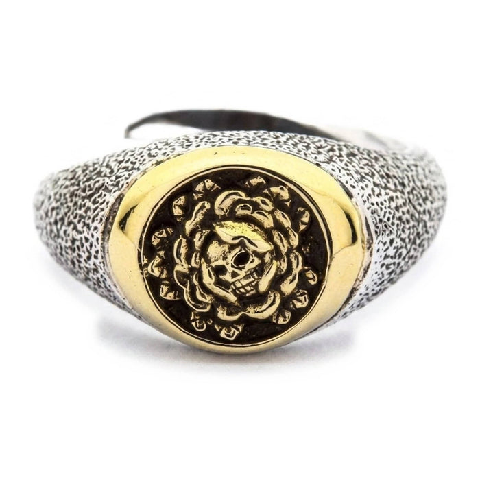 Front view of .925 sterling silver skull and rose ring with gold brass signet face and stippled antiqued band