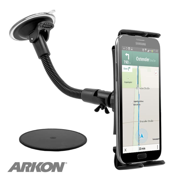 A smartphone in a Slim-Grip® Ultra Windshield Phone Car Mount with 8.5 Inch Arm displays navigation on the windshield, held by a flexible suction-cup mount, with the ARKON logo visible on the device’s lower left corner.