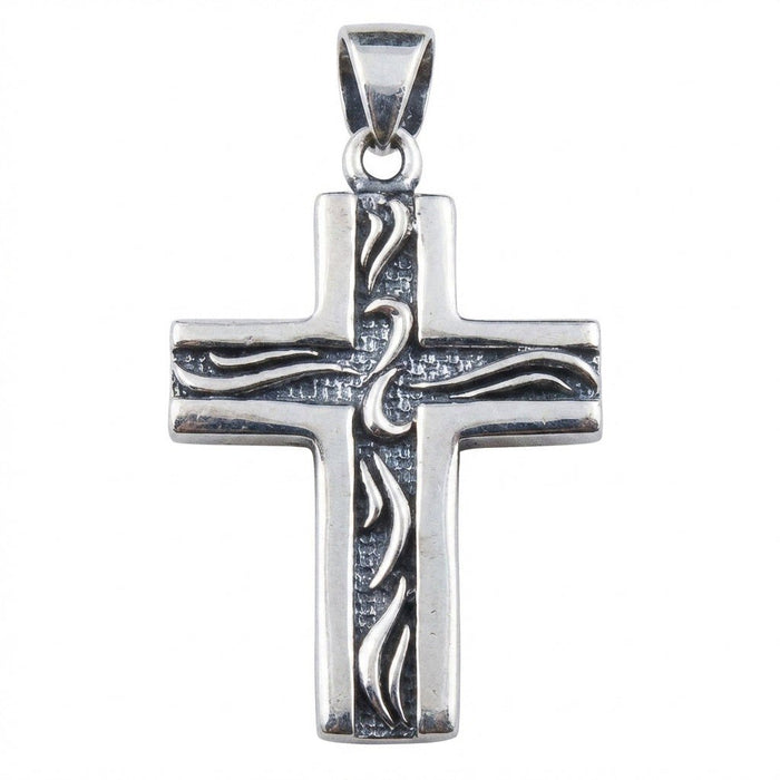 Clear studio shot detailing the polished edges, raised tribal motif, and textured dark center of the silver cross.