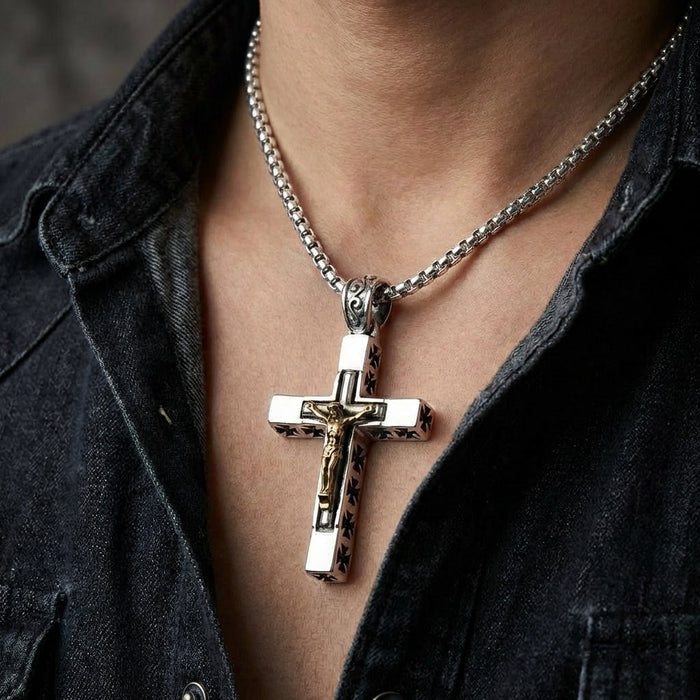 Man wearing heavyweight sterling silver crucifix pendant with gold-plated corpus on a silver box chain with denim jacket
