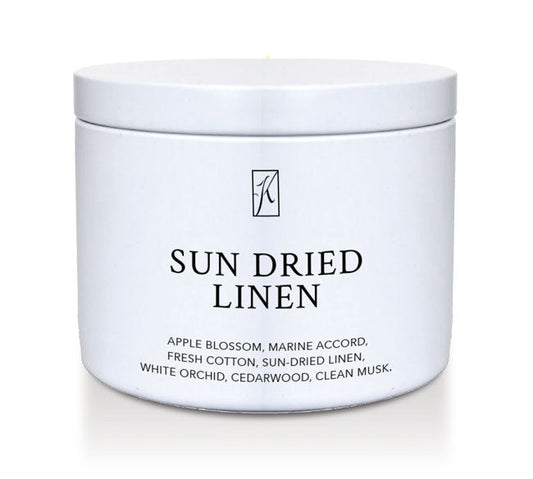 'Sun Dried Linen' fragrance candle in a white tin container on a white background