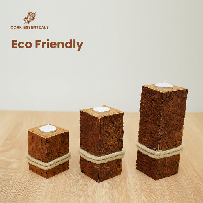 Three cork candle holders with candles on a wooden surface, branded as Cork Essentials.