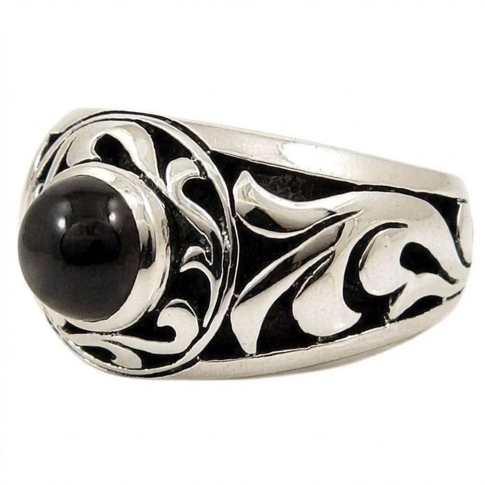 Angled view highlighting the raised, polished silver tribal patterns against a dark oxidized background on the band.