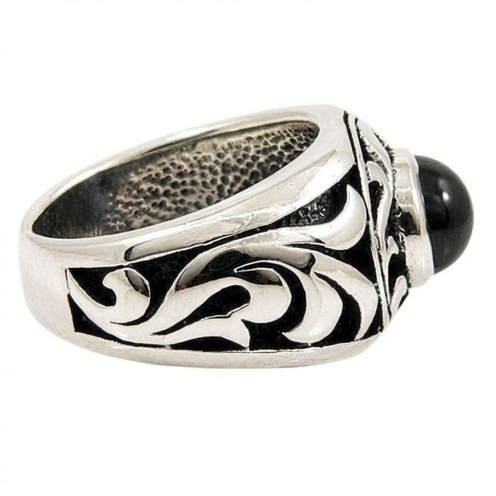 Interior view revealing a stippled oxidized texture inside the silver band, alongside polished exterior tribal swirls.