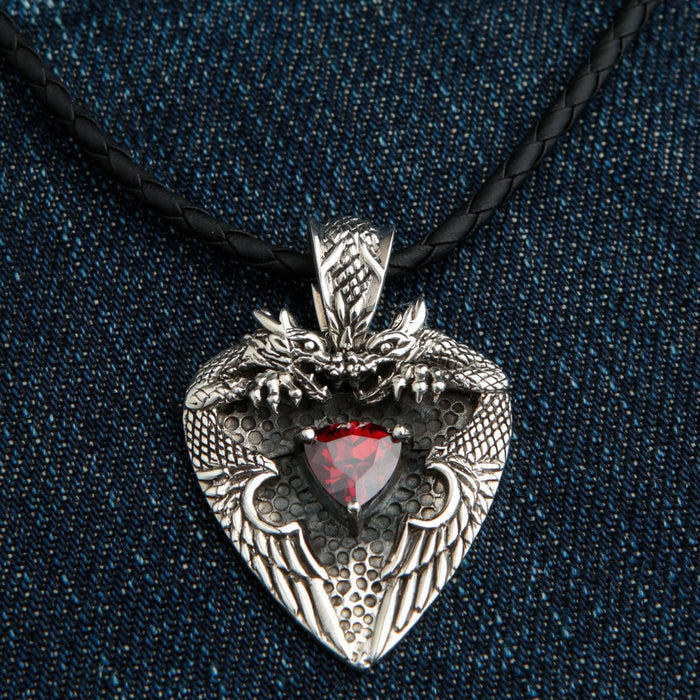The heavy sterling silver twin dragon heart pendant with a red garnet, shown on a leather chain.