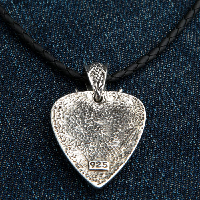 Textured reverse in a guitar-pick outline, patterned bail above and a 925 stamp on the oxidized surface.