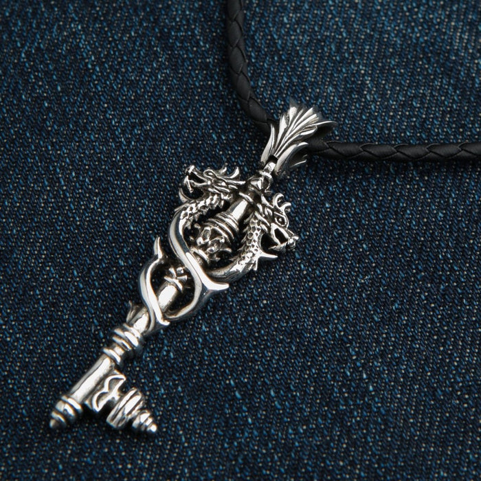 Sterling silver Viking dragon key pendant hanging on black braided leather cord necklace
