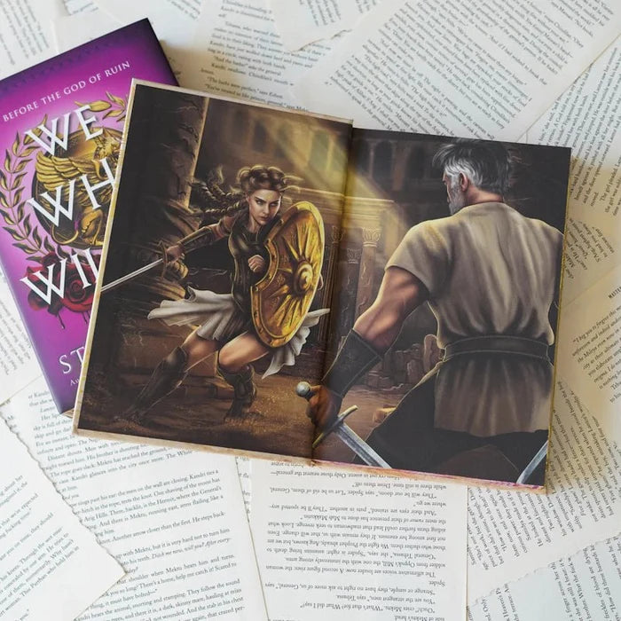 We Who Will Die LitJoy Edition open to interior full-color illustration — female warrior with gold shield facing an older warrior in a dungeon setting, beside the purple cover, from LitJoy Winter Romantasy TBR Box