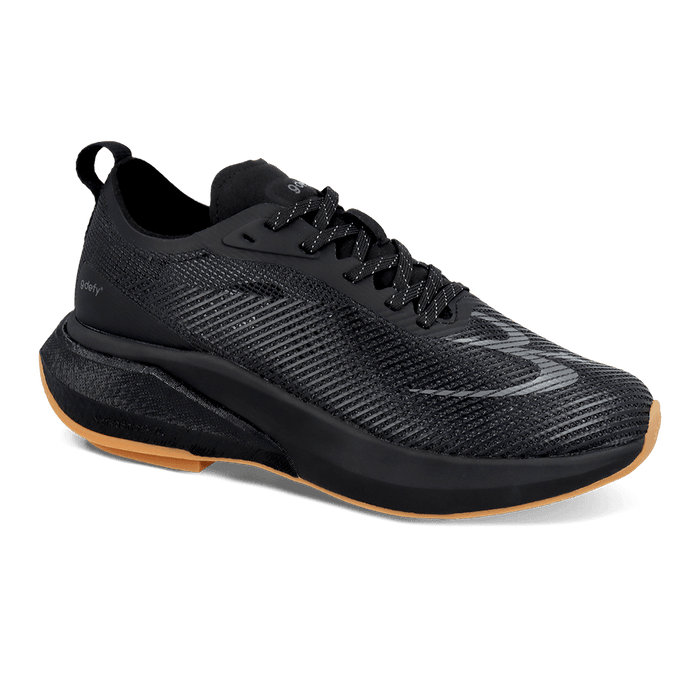 Black running shoe with a mesh upper, reflective laces, and a tan accent on the sole. Features gdefy branding.
