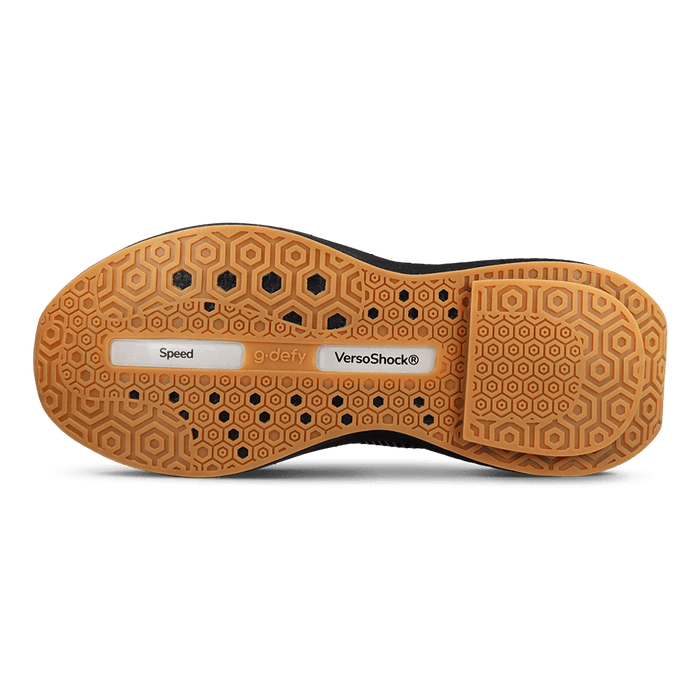Shoe sole with tan hexagonal tread pattern and black accents, featuring "Speed", "g.defy", and "VersoShock®" labels.