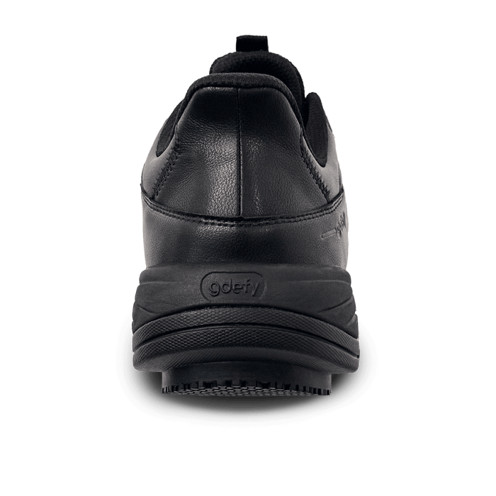 Black athletic shoe, back view, with a textured leather-like upper and a thick rubber sole featuring the gdefy logo.