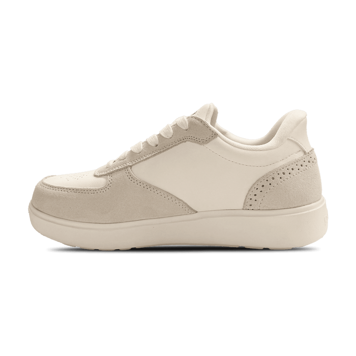 Off-white leather and suede sneaker with perforated accents and cream laces, shown from the inside profile.