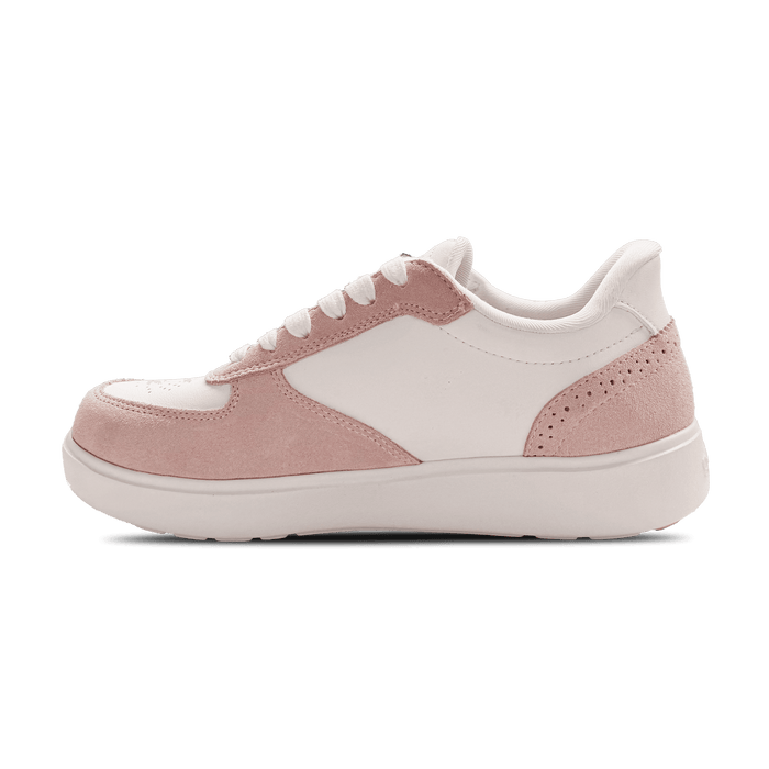 Women's low-top sneaker with white synthetic leather and blush pink suede panels, white laces, side view.