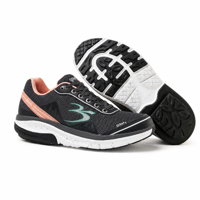 Black mesh athletic shoes with peach trim, green logo, and speckled white midsole. One shoe is upright, the other shows its b