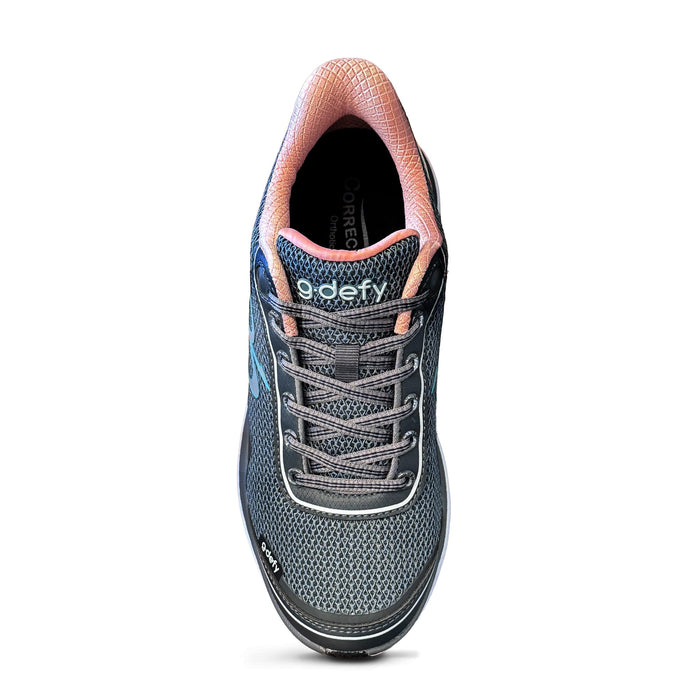 Running shoe with dark grey mesh upper, peach interior lining, grey laces, and 'g-defy' logo on the tongue.