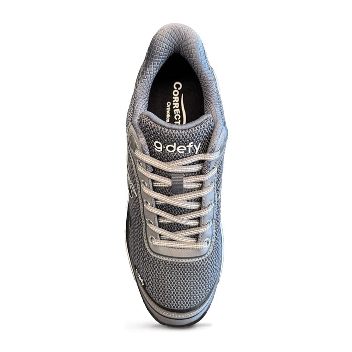 Top view of a gray mesh athletic shoe featuring gray laces, '9 defy' branding, and a 'Correct Orthotics' insole.