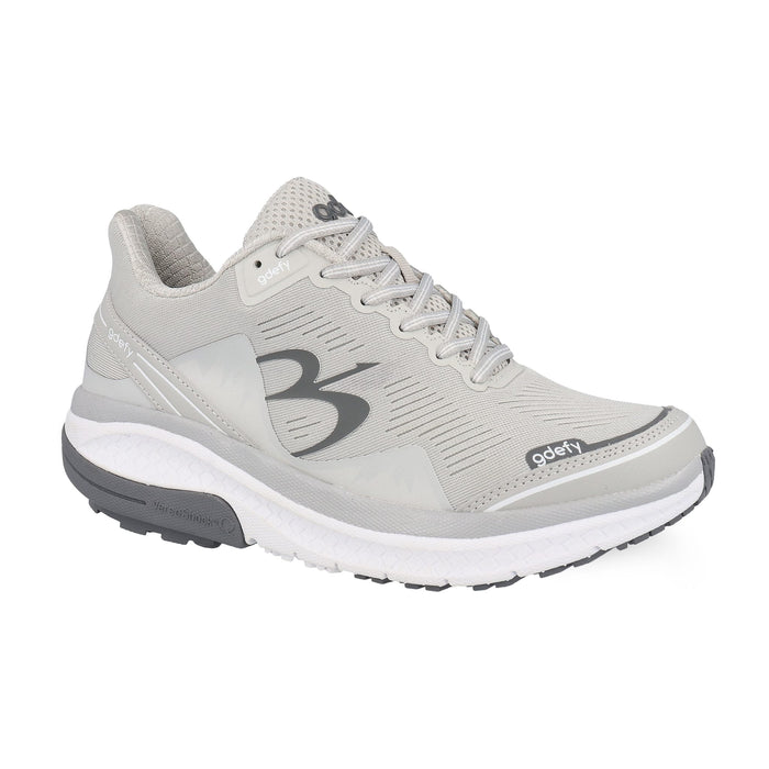 Light grey gdefy athletic shoe with a white midsole and dark grey outsole, featuring VersoShock technology.