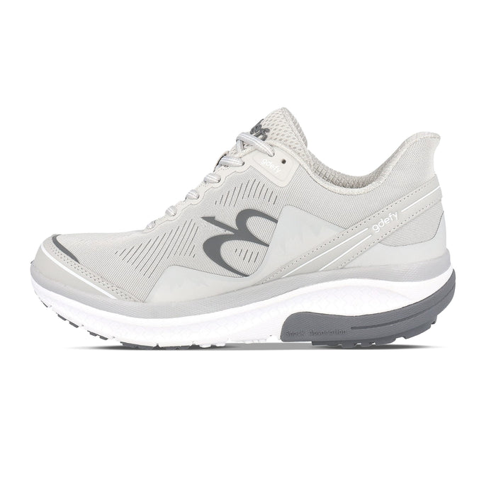 Light grey running shoe with white and dark grey sole, featuring 'gdefy' branding and 'Shock Absorption'.