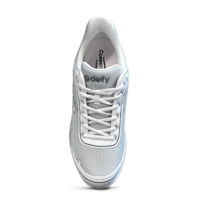 White athletic shoe with mesh upper and white laces, seen from above. Features 'gdefy' branding on the tongue.